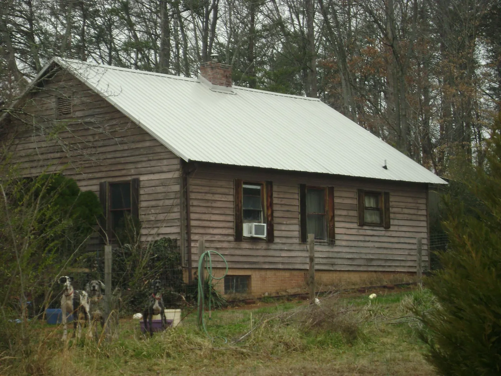 White metal roof on an old wood sided farmhouse, from a Metal Roof Installation job in Tieton